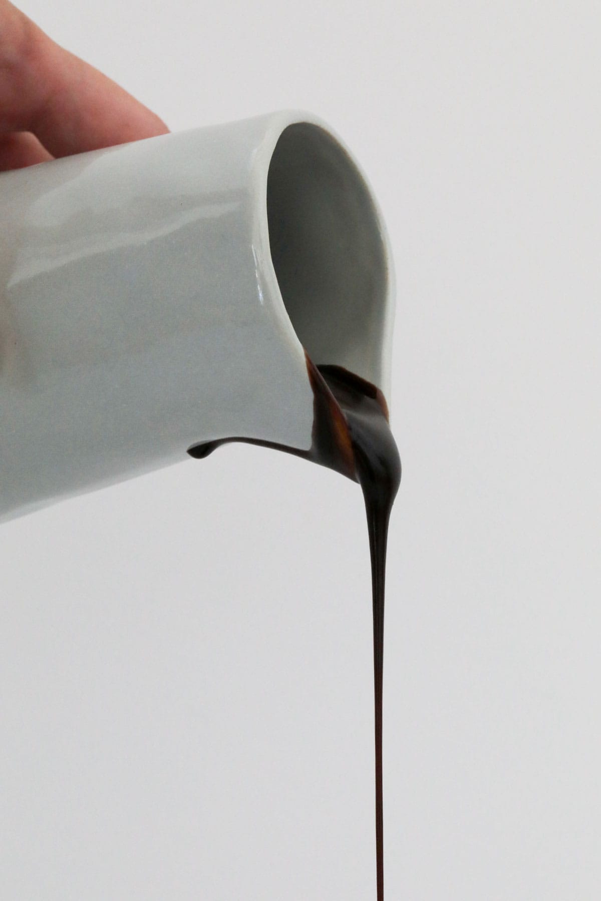 A jug pouring chocolate sauce.