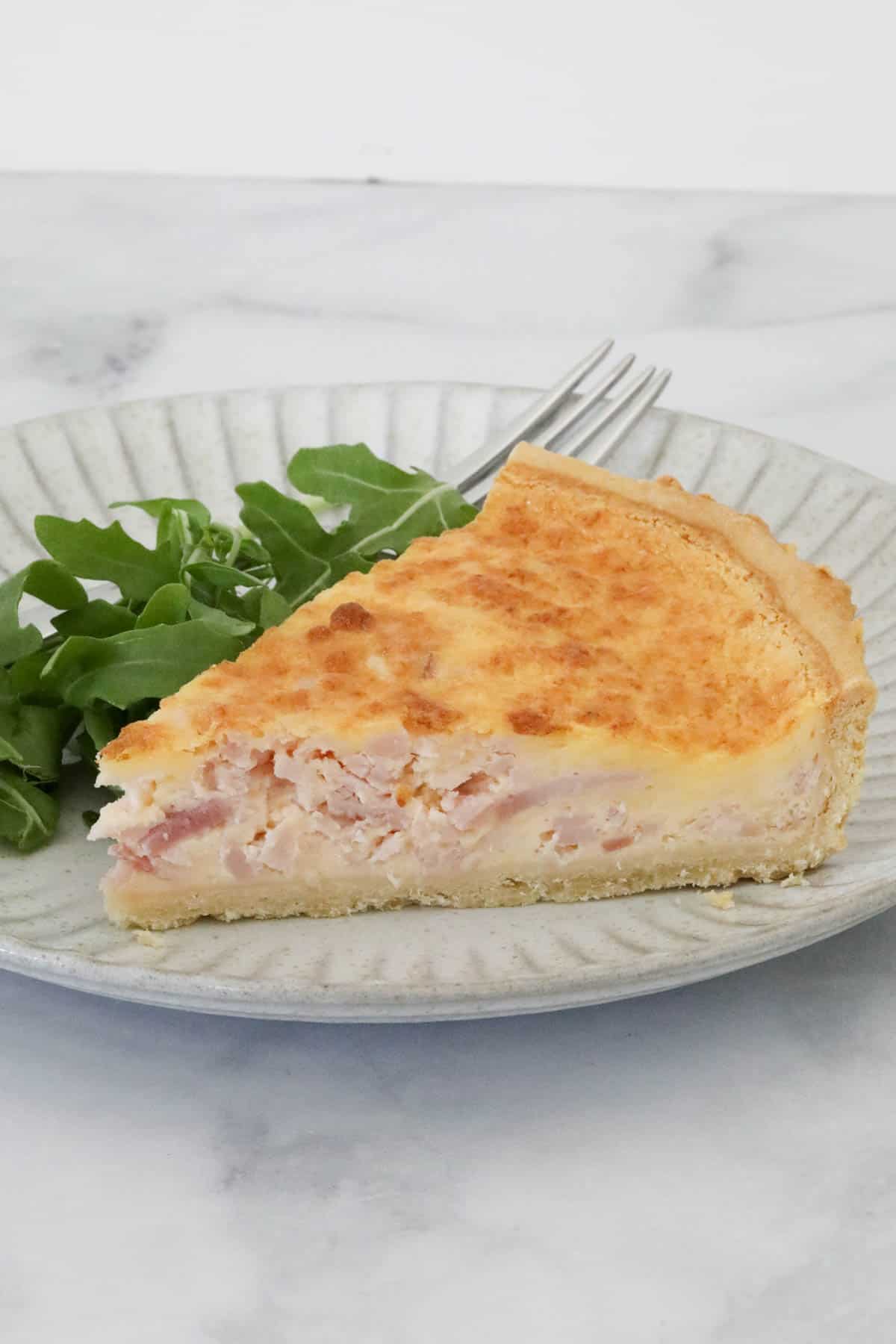 A piece of egg and bacon quiche.