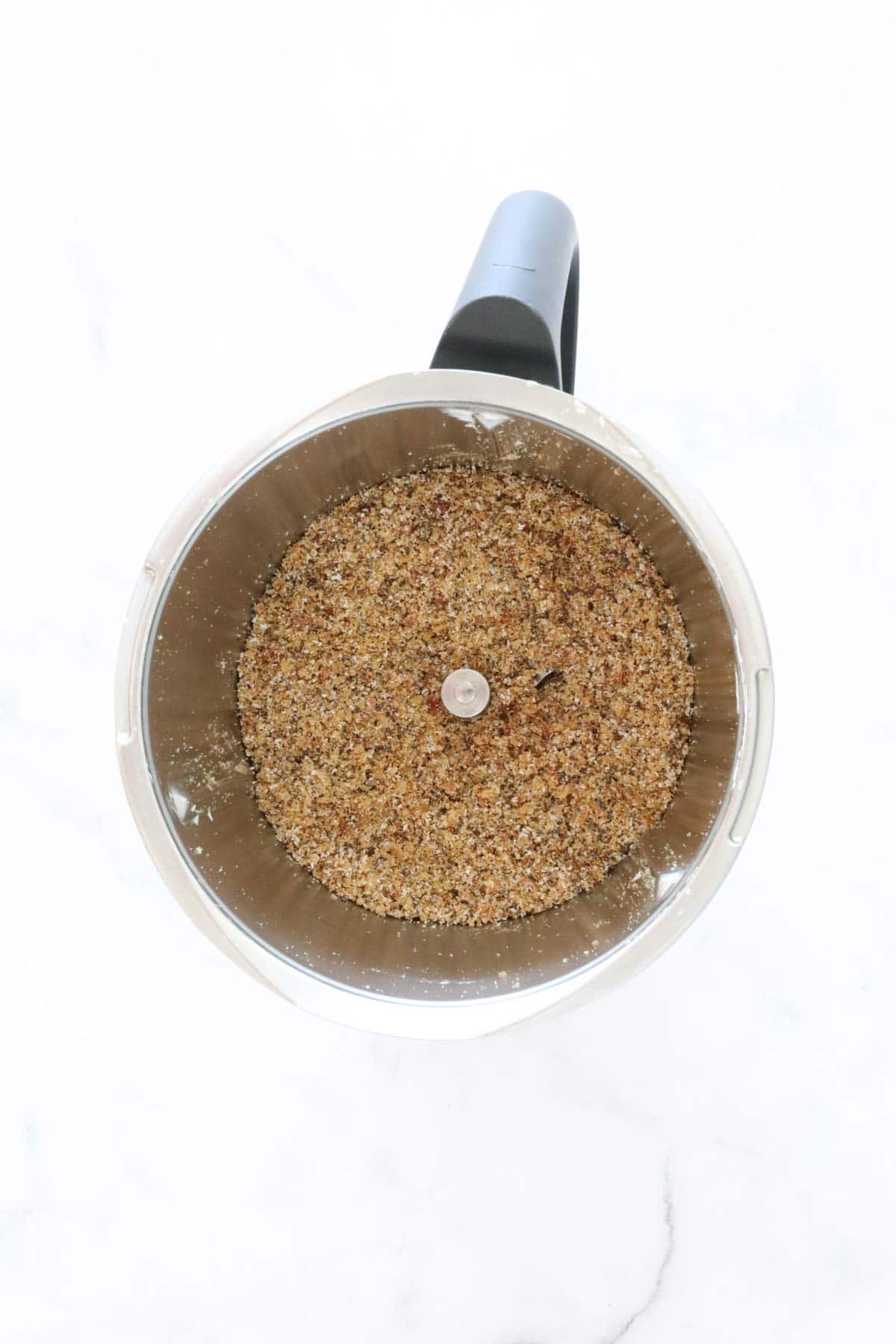 A Thermomix bowl filled with mixture.