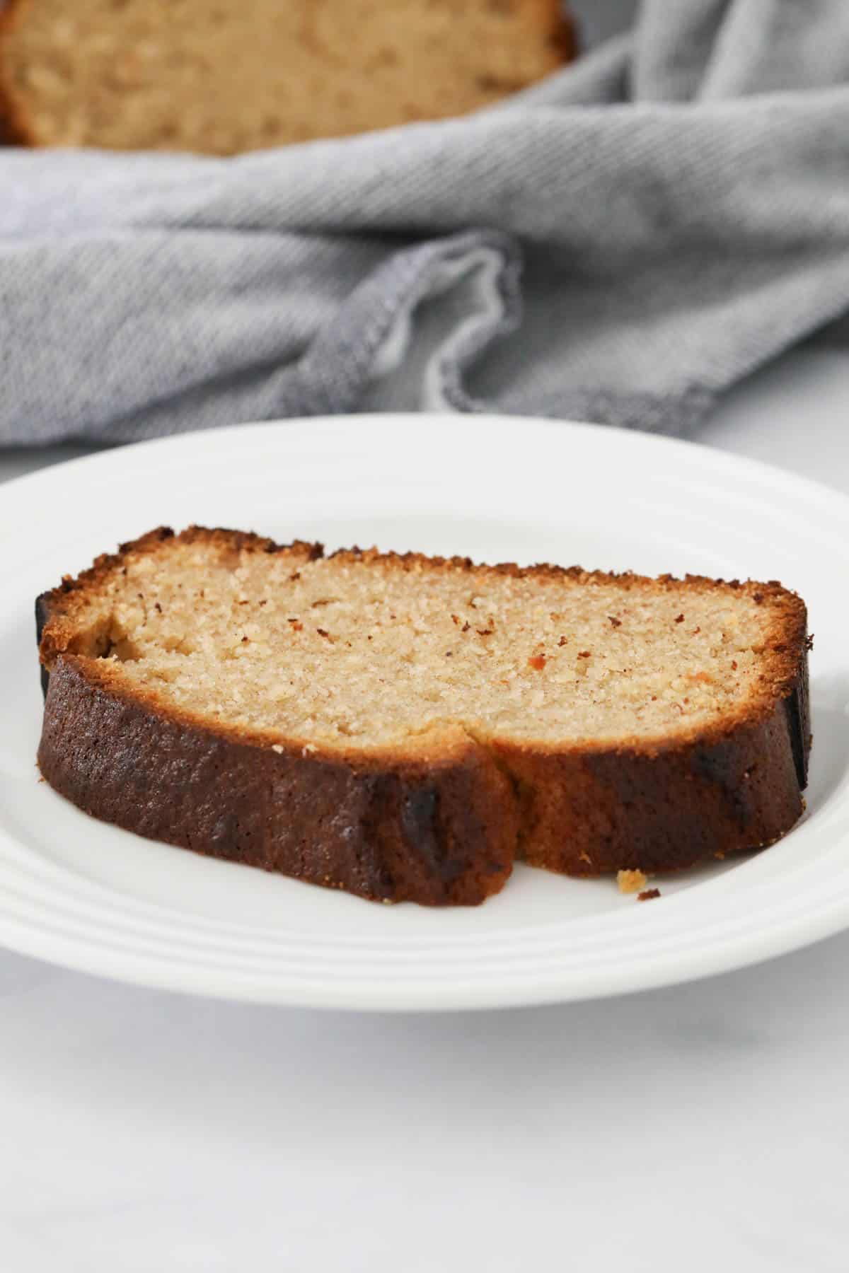 A slice of banana bread on a plate.