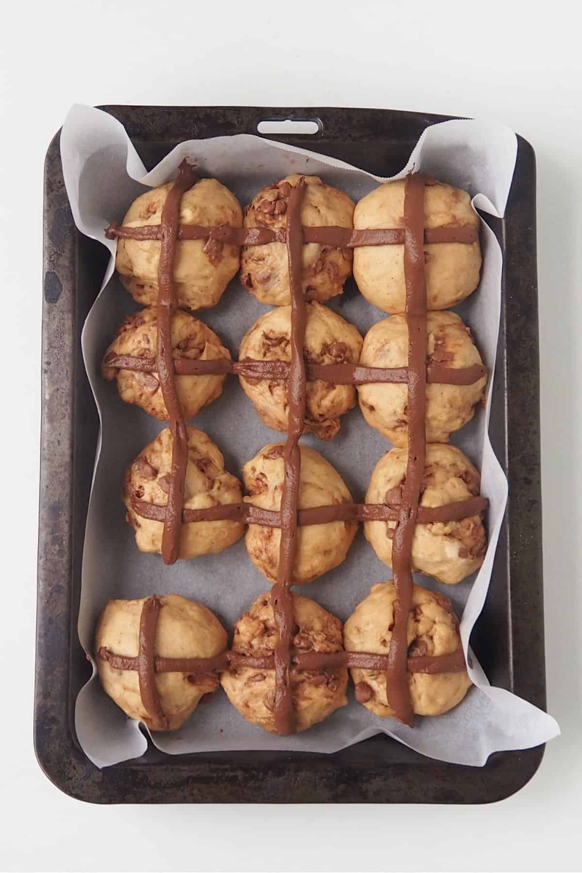 Chocolate Chip Hot Cross Buns with chocolate crosses before going into the oven.