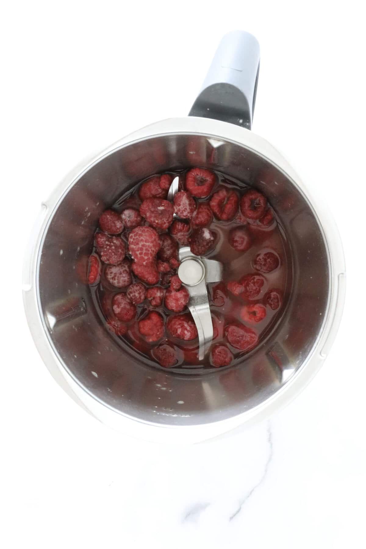 Raspberries and liquid in a Thermomix.