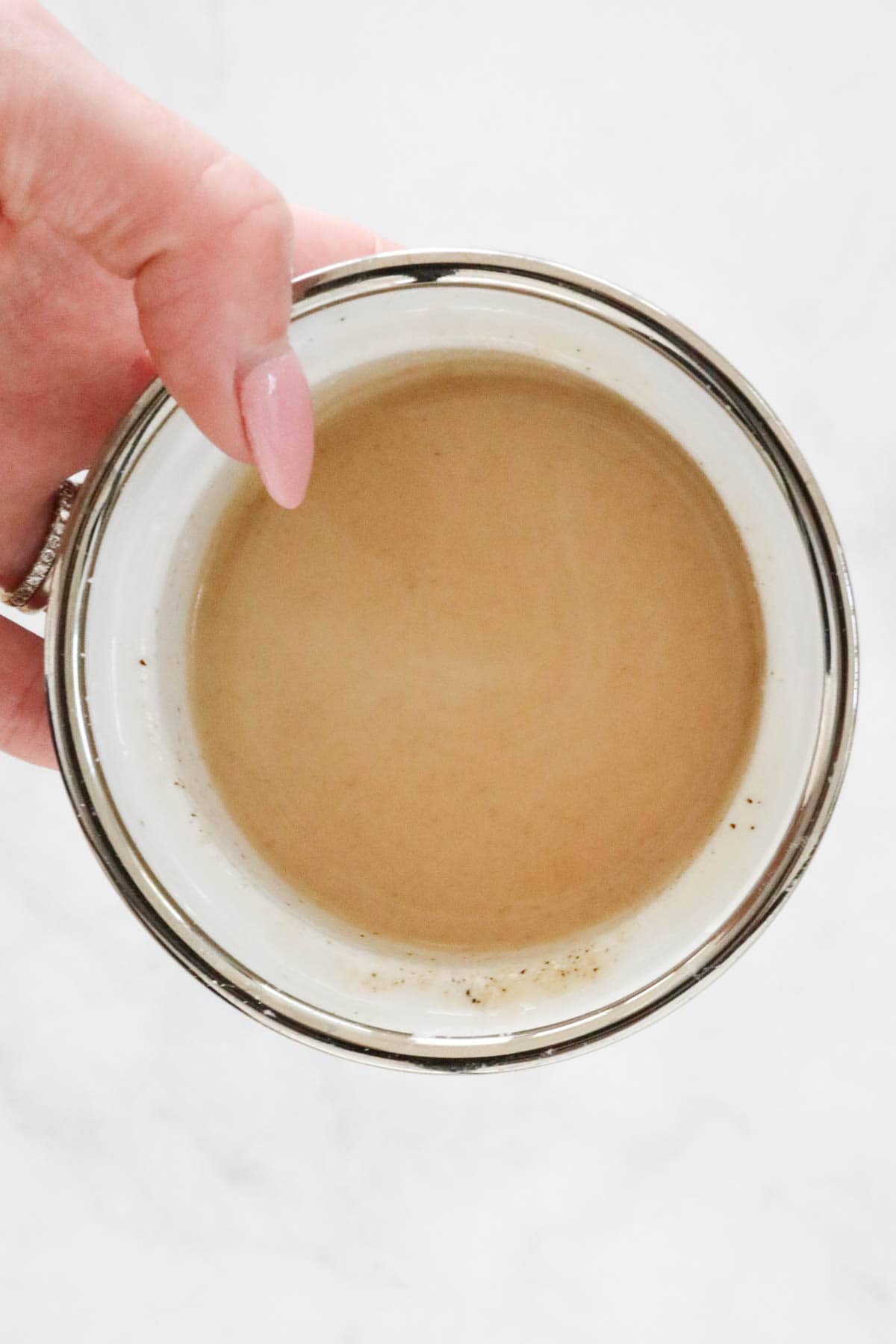 A ramekin filled with creamy liquid.