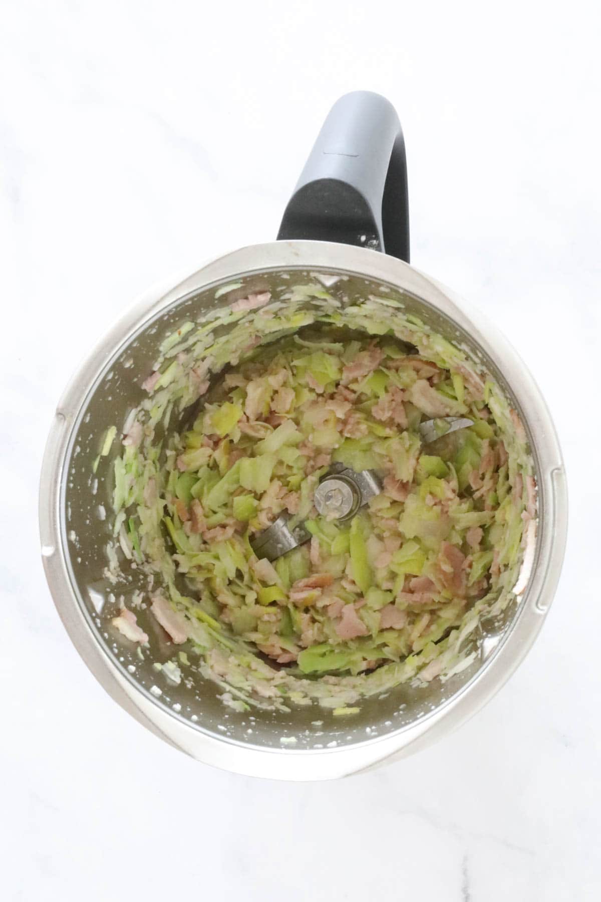 Sauteed leek and bacon in a Thermomix.