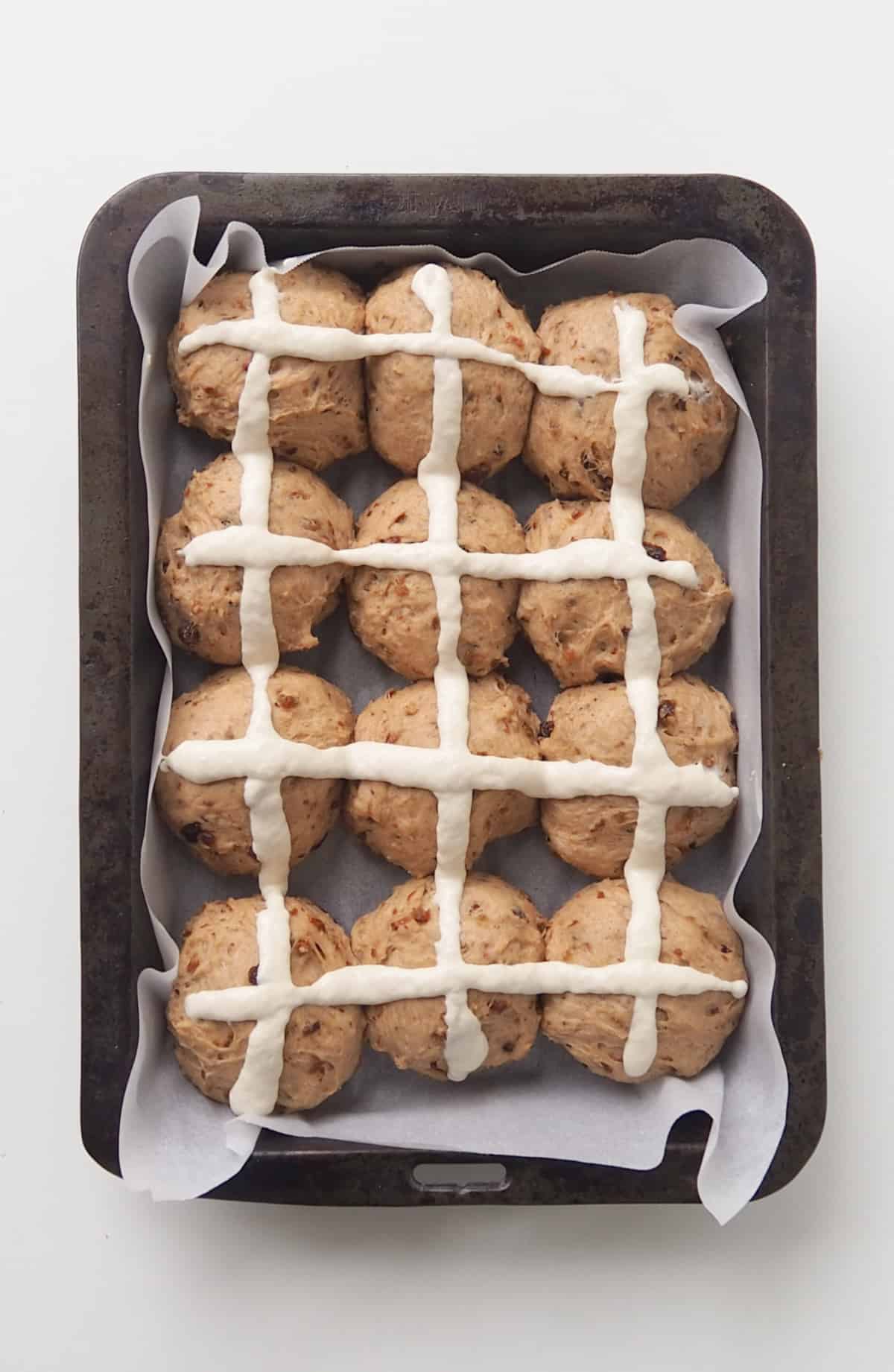 Hot Cross Buns with crosses piped ready to go into the oven.
