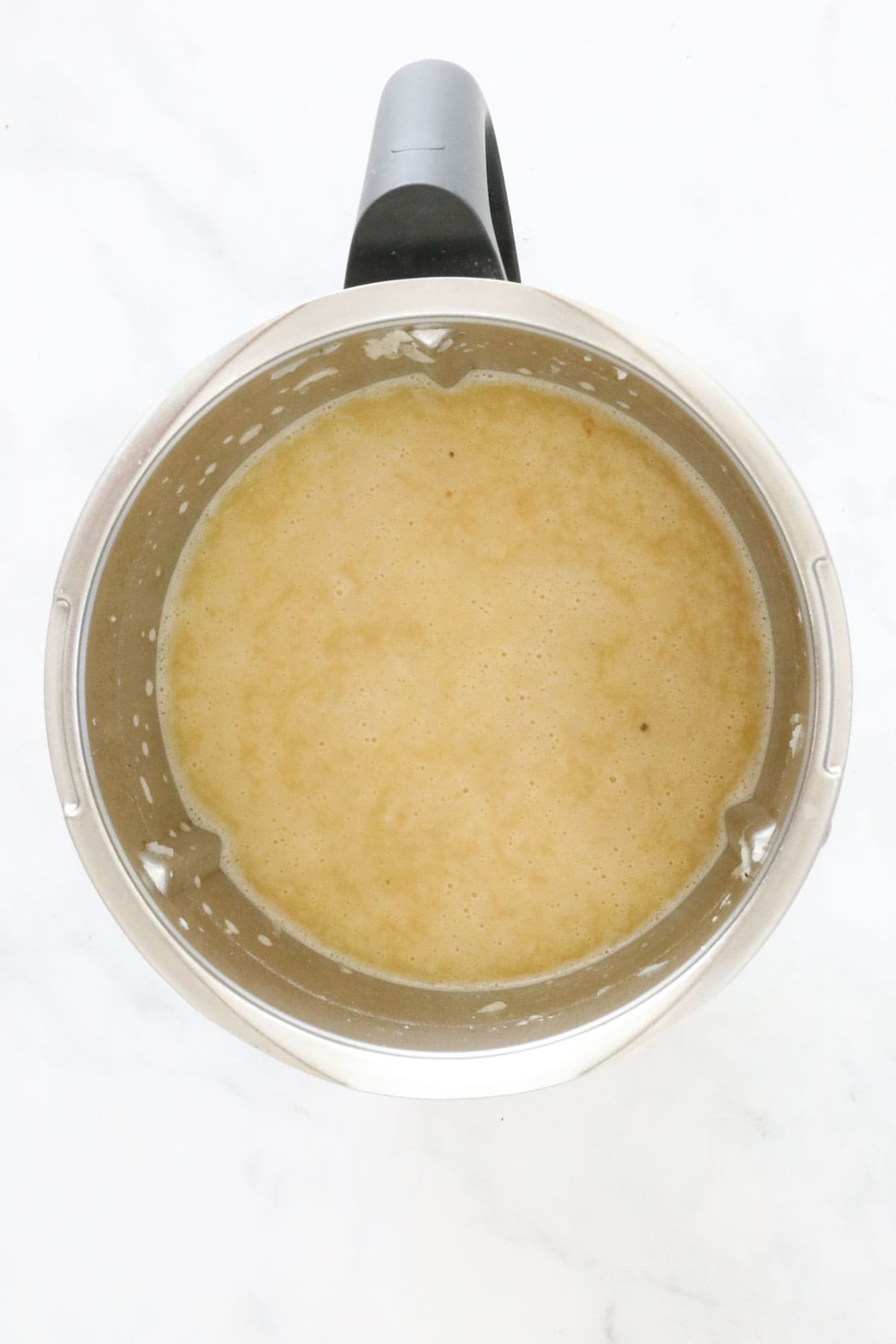 Yellow liquid in a Thermomix bowl.