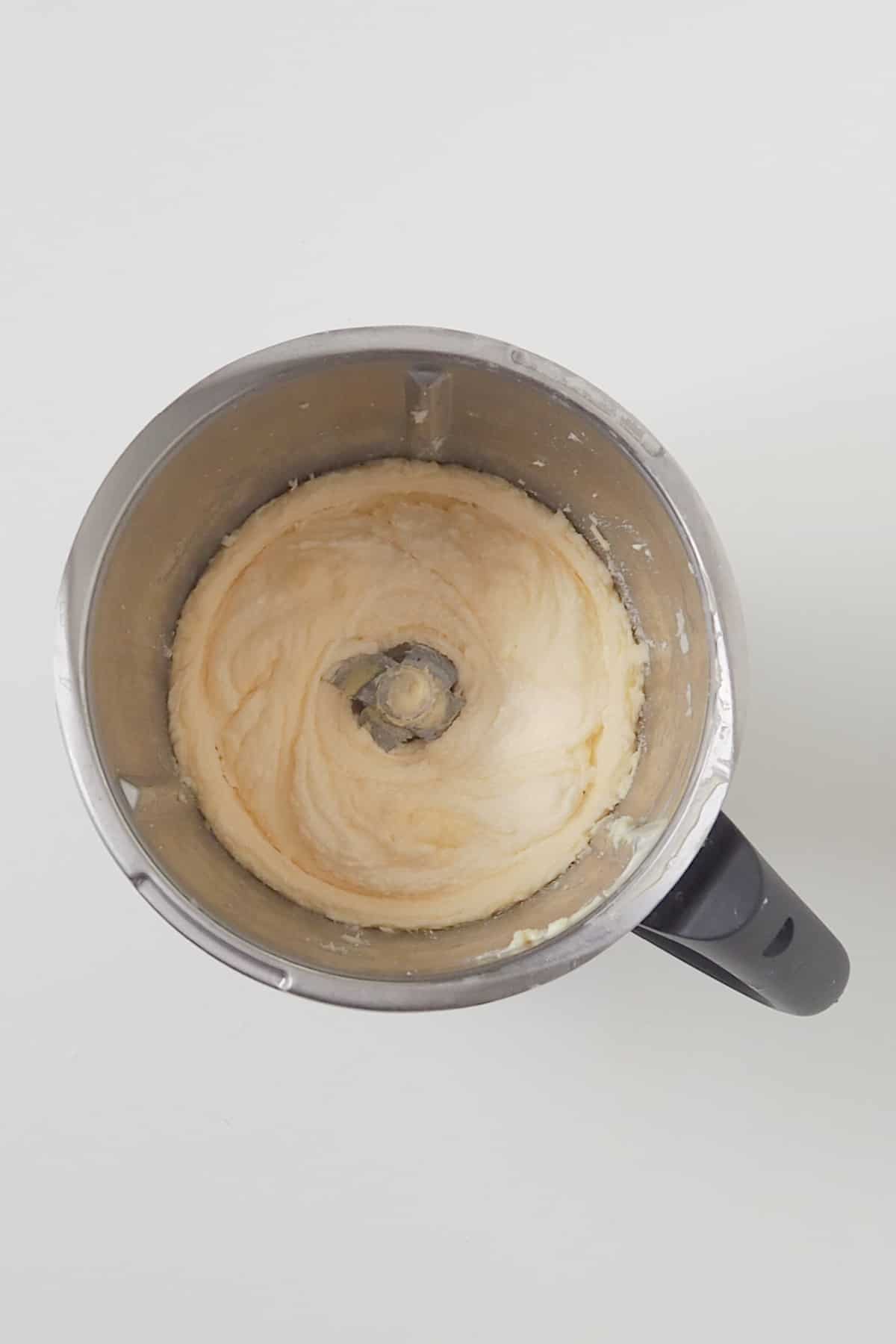 Combined ingredients for a custard cake in a thermomix bowl.