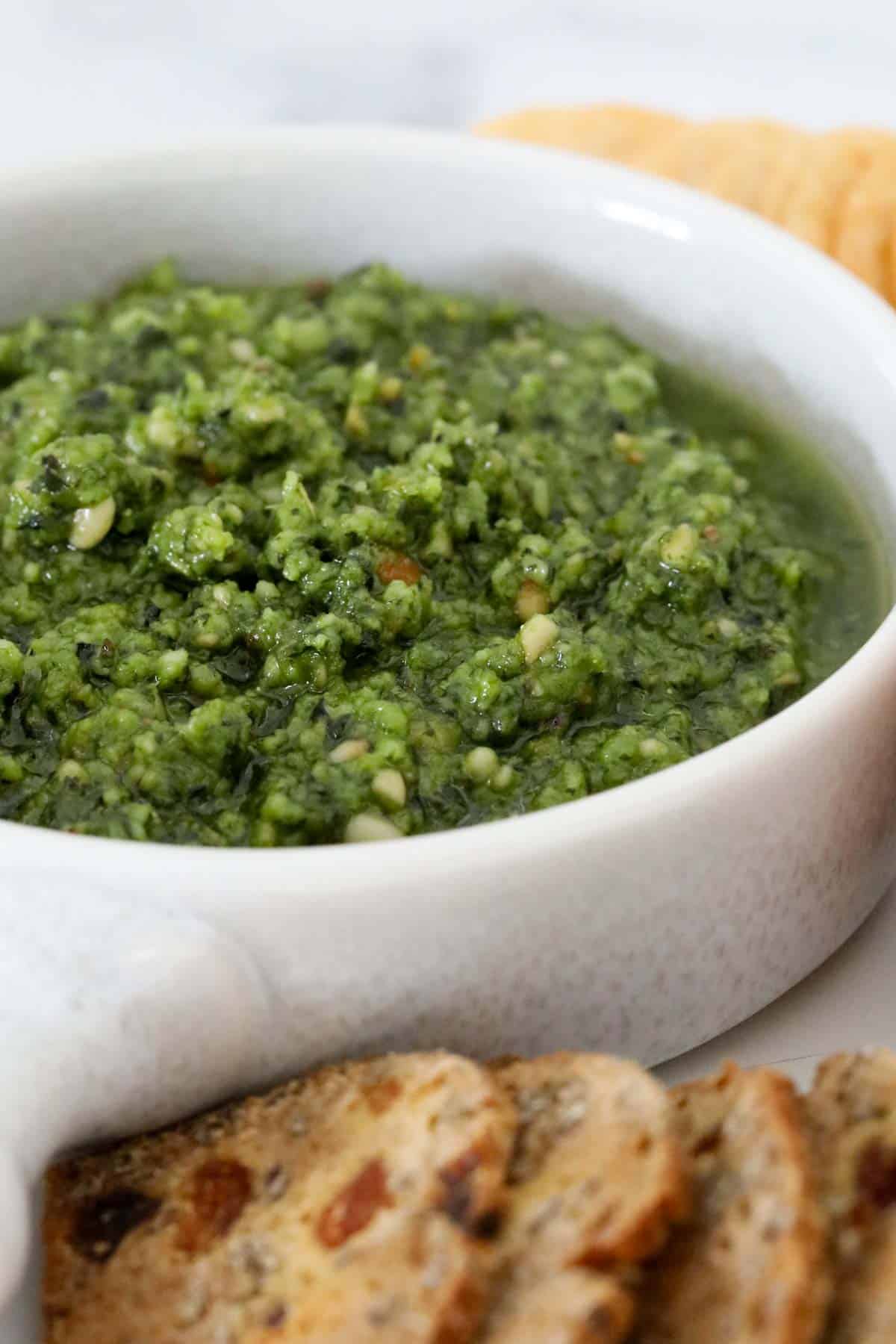 Green pesto in a bowl.