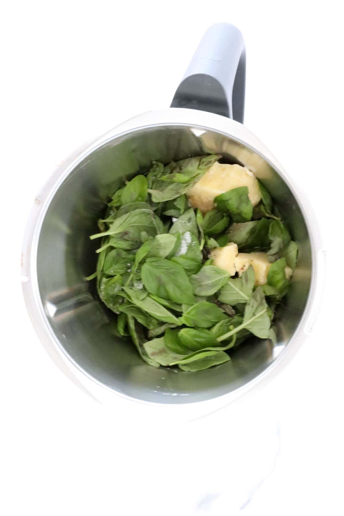 Parmesan and basil leaves in a Thermomix.