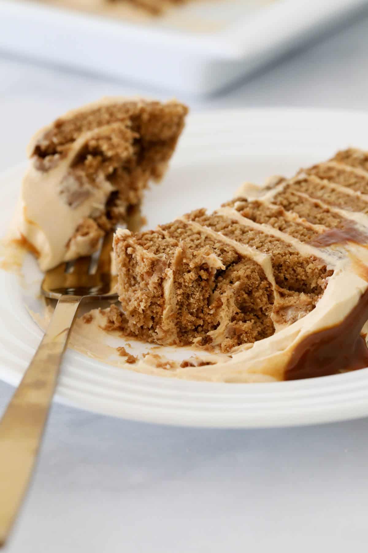 A gold fork taking a piece of gingernut log.