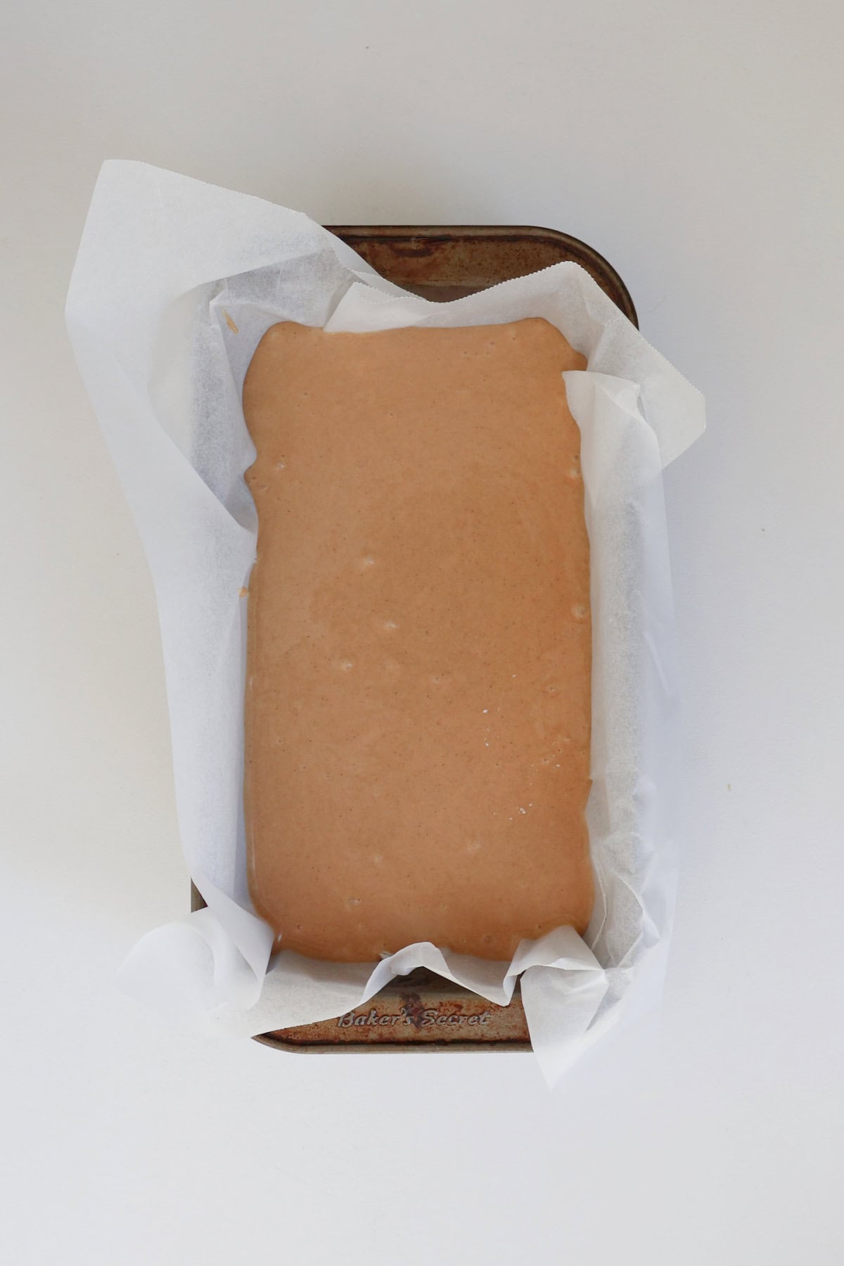 Gingerbread loaf mixture in a baking dish ready to go into the oven.