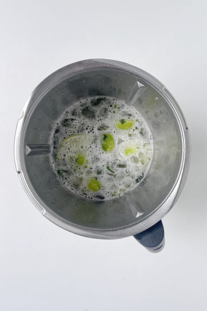 Mojito ingredients mixed together in a Thermomix bowl.
