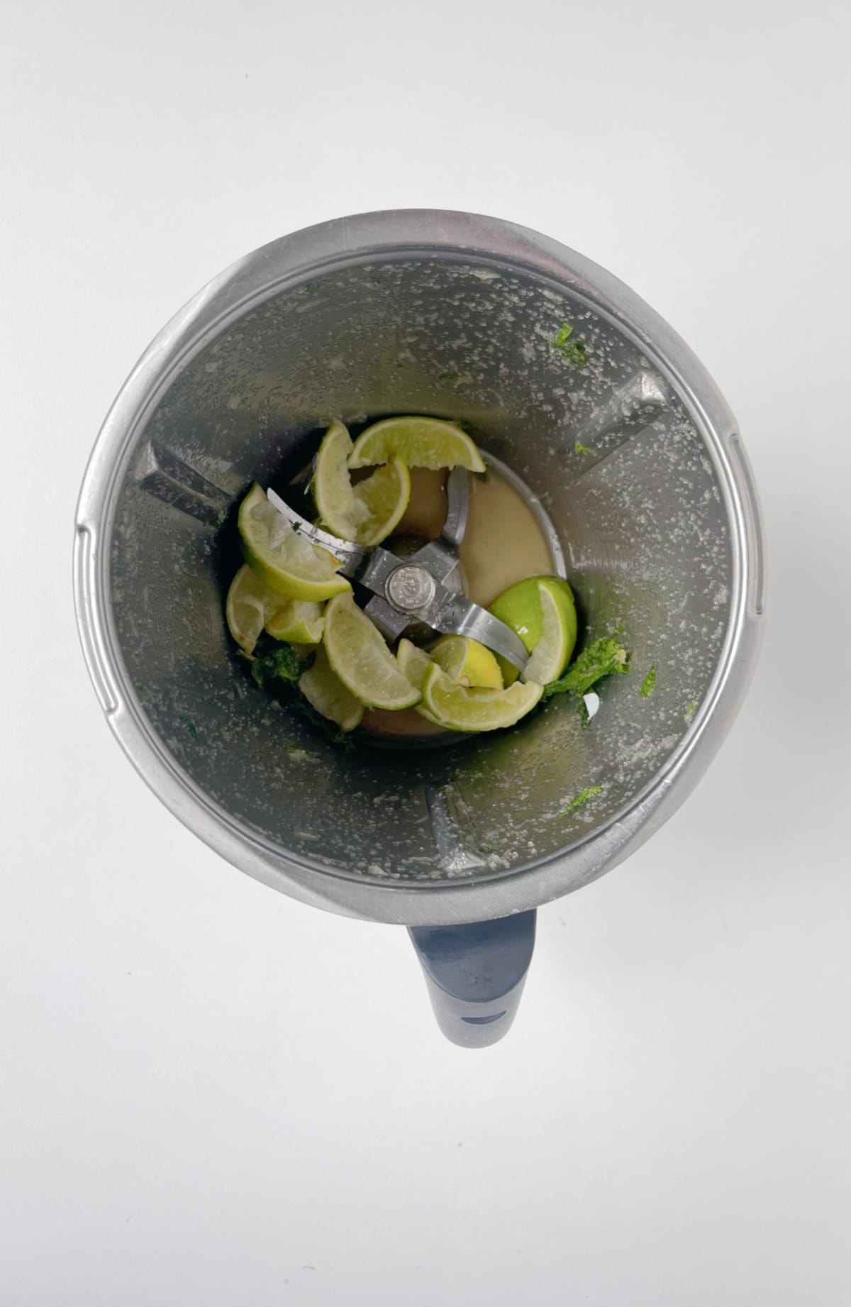 mint, lime and raw sugar combined in a THermomix bowl.