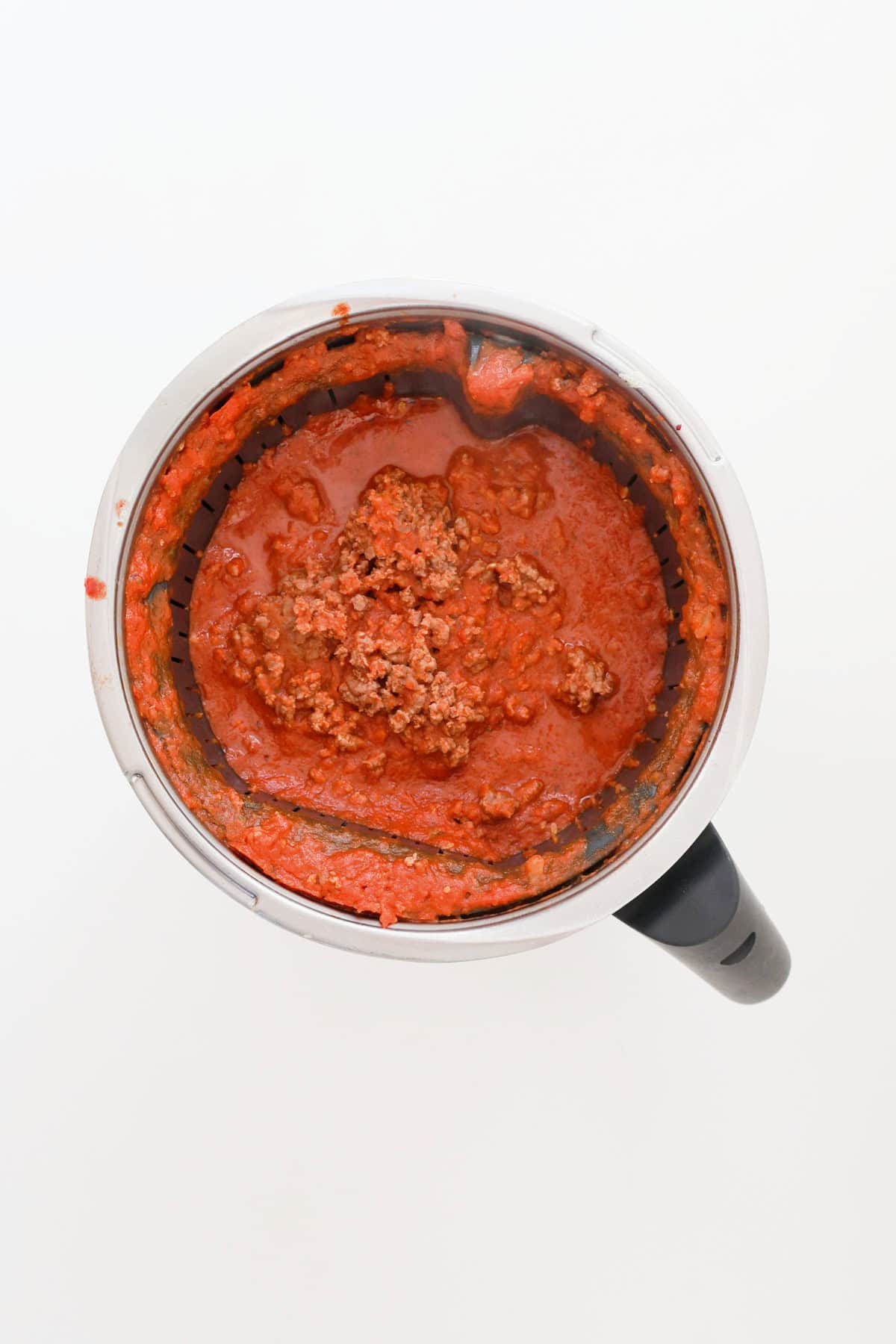 Beef and vegetable sauce ingredients in a thermomix bowl.