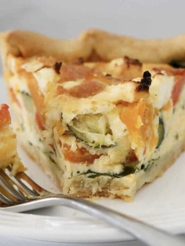 A slice of roasted vegetable quiche.