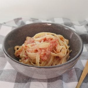 Side view of Carbonara in a grey bowl.