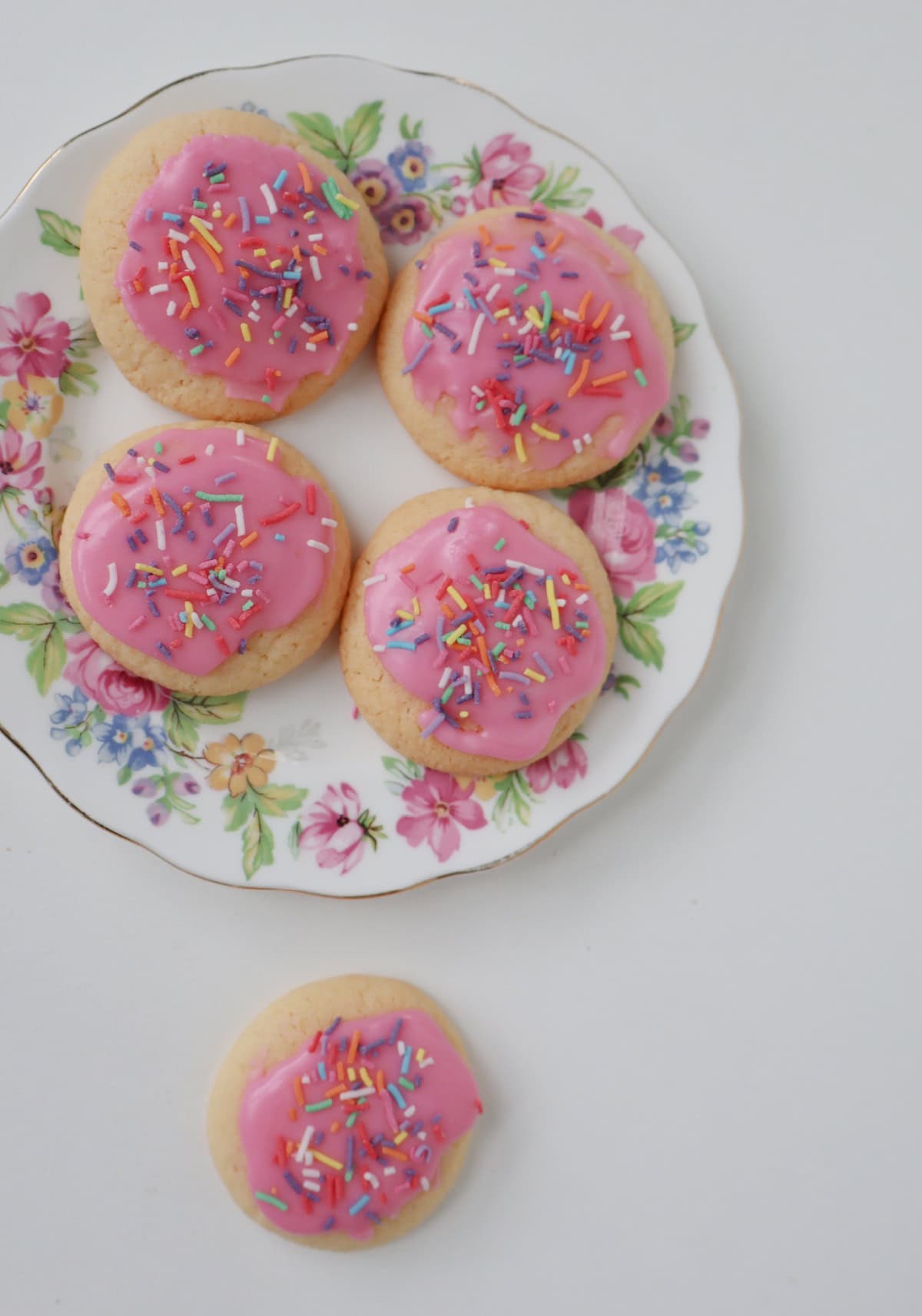 Overhead view of fairy biscuits on a flowered plate.