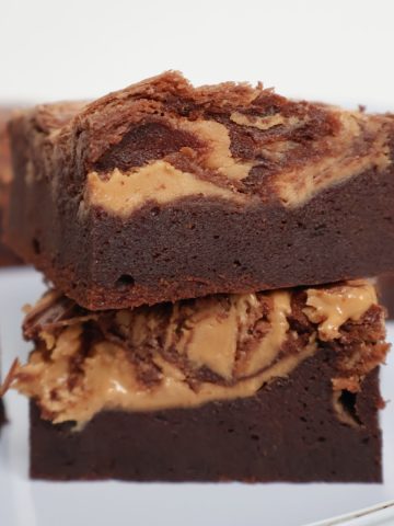 Two pieces of Peanut Butter Brownies stacked on top of each other.