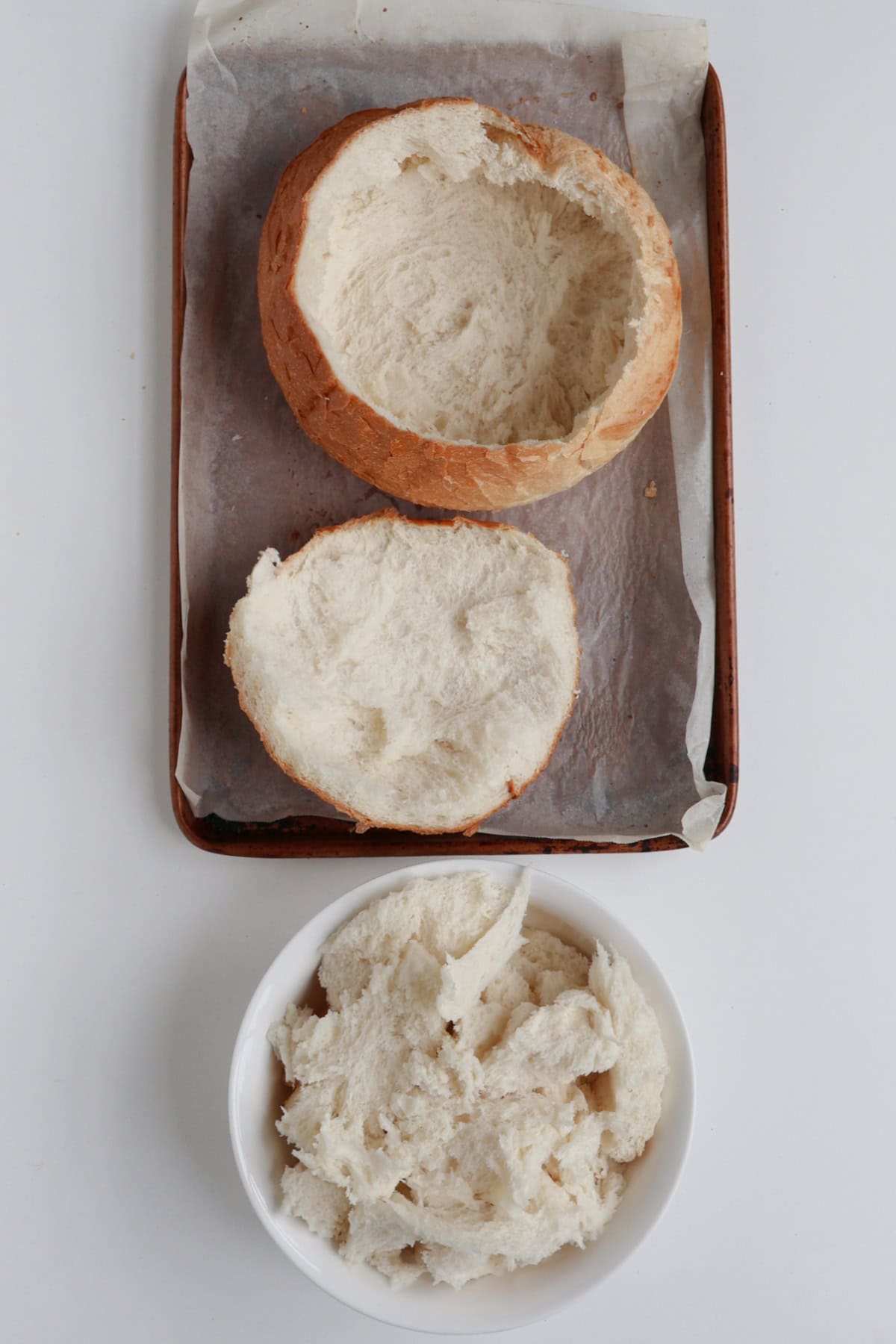 Hollowed out cob loaf on a baking tray.