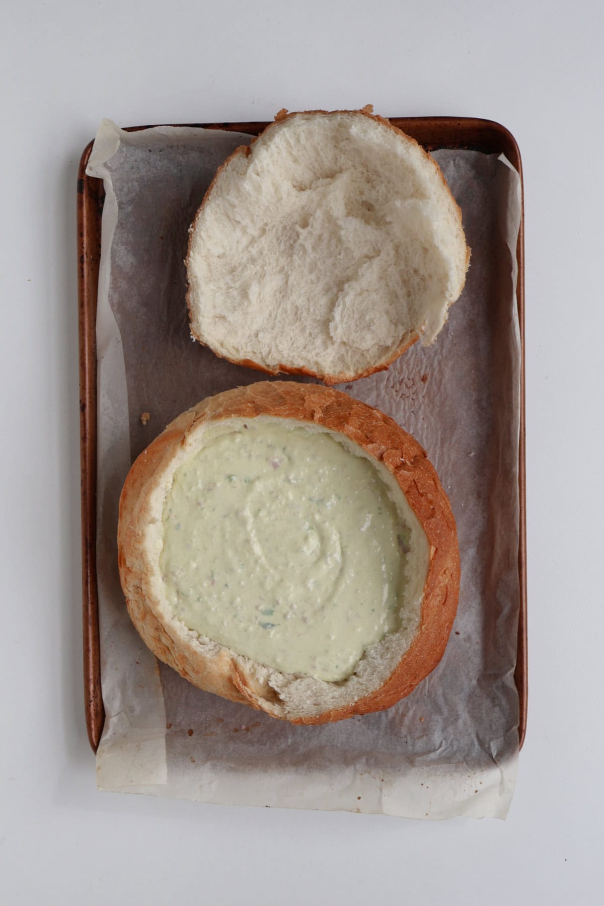 Cob loaf dip ready to go into the oven on a baking tray.