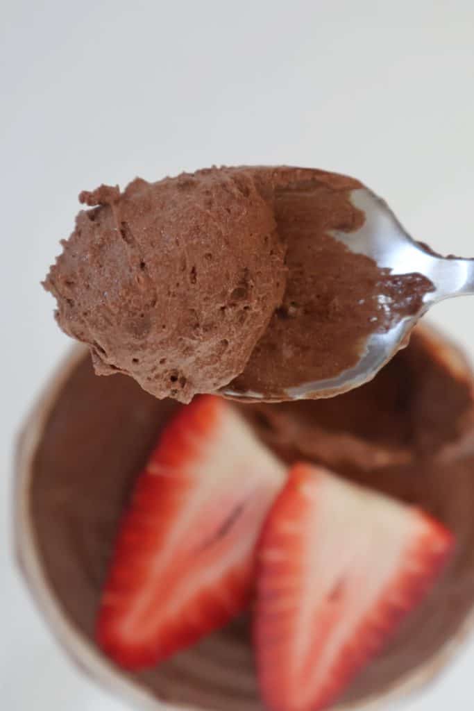 Siver spoon with a scoop of chocolate mousse.