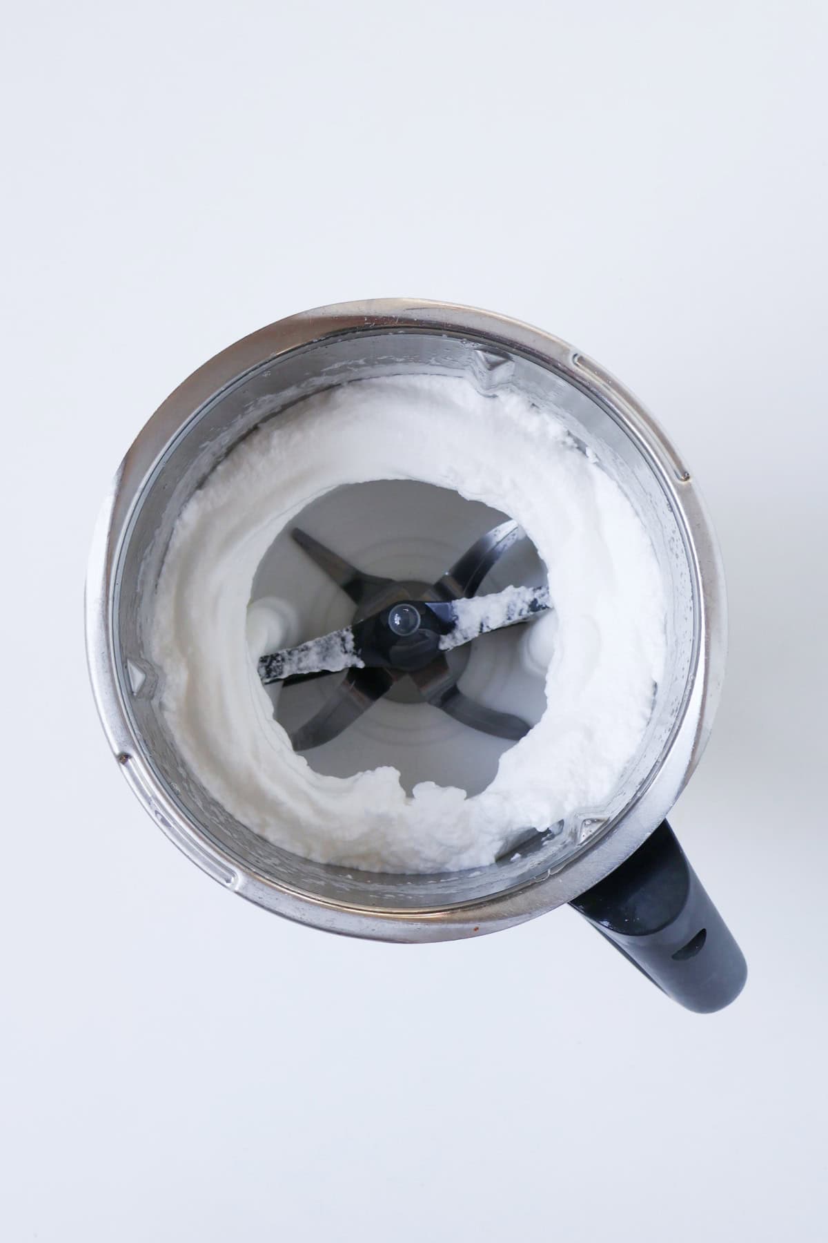 Whipped egg whites in a thermomix bowl.