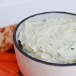 Side view of Thermomix Herb and Garlic Dip in a white bowl.