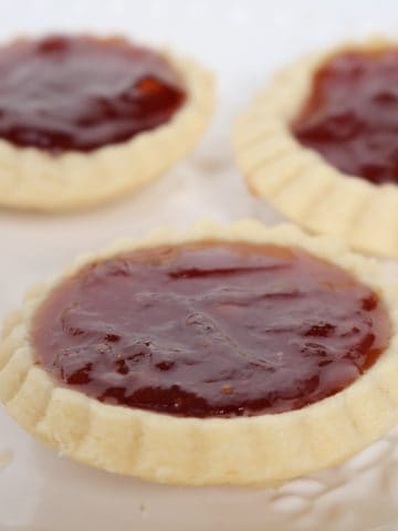 Close up side view of Jam Drops on a white platter.