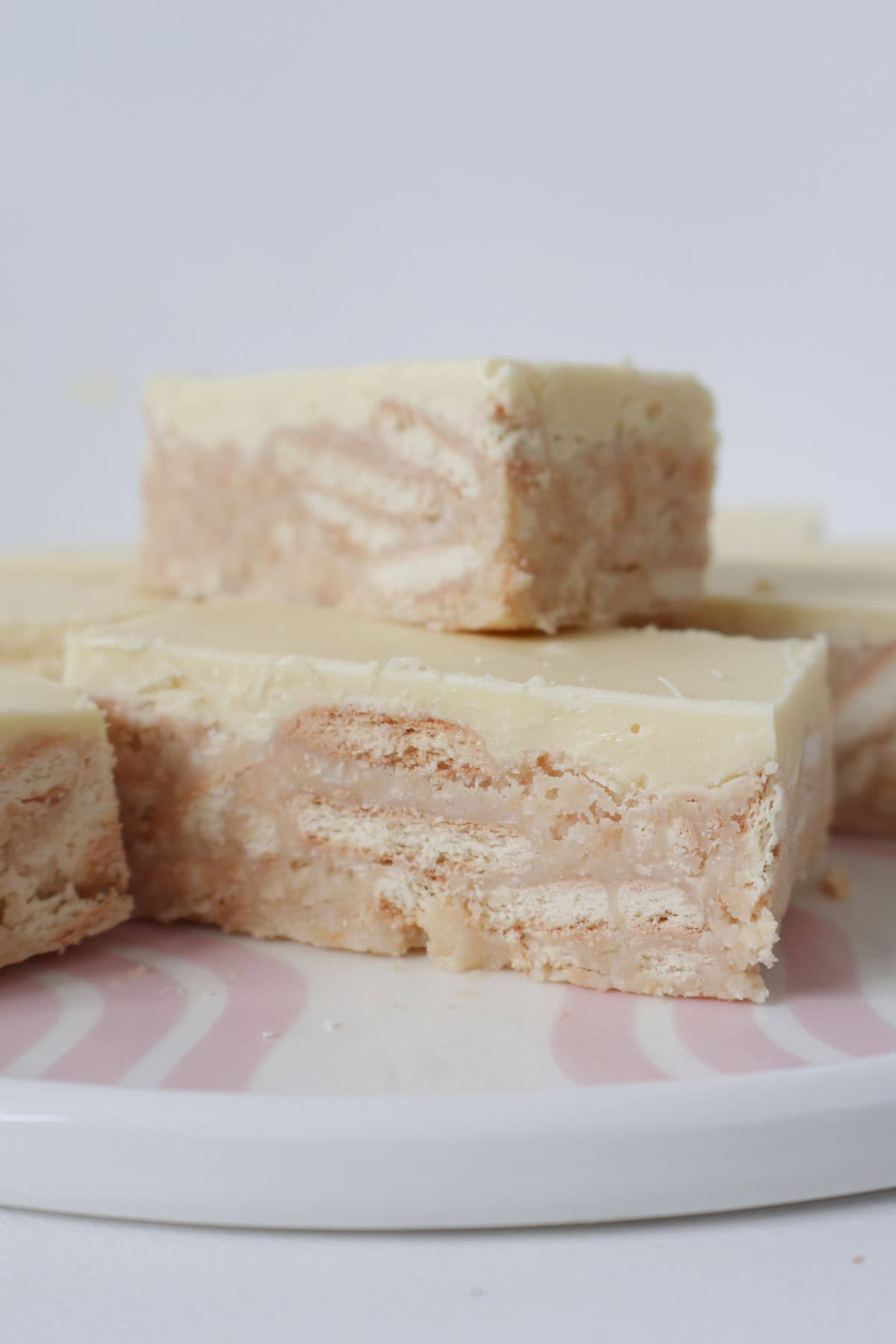 Slices of Thermomix White Chocolate Hedgehog Slice stacked on top of each other.