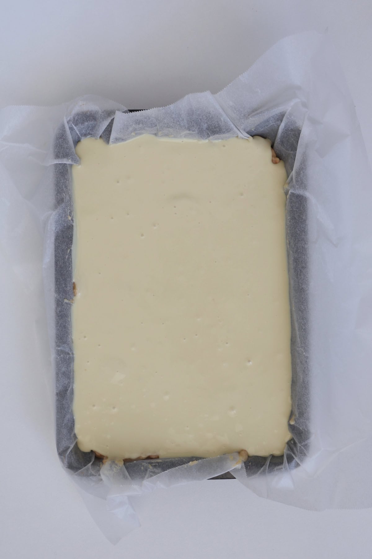 melted chocolate on top of white chocolate hedgehog slice.