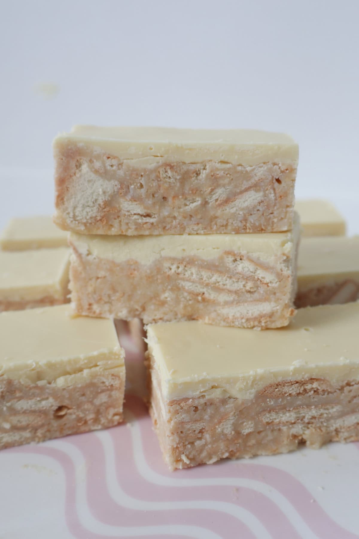 Slices of Thermomix White Chocolate Hedgehog Slice stacked on top of each other.