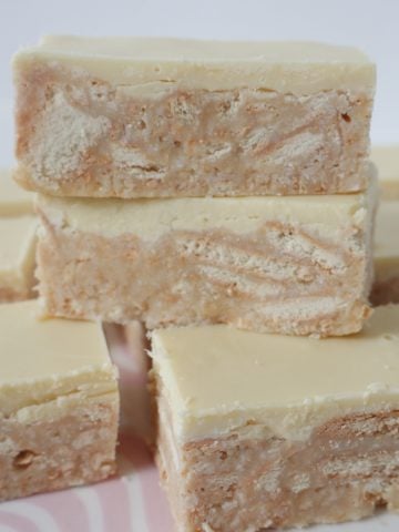 Slices of Thermomix White Chocolate Hedgehog Slice stacked on top of each other.