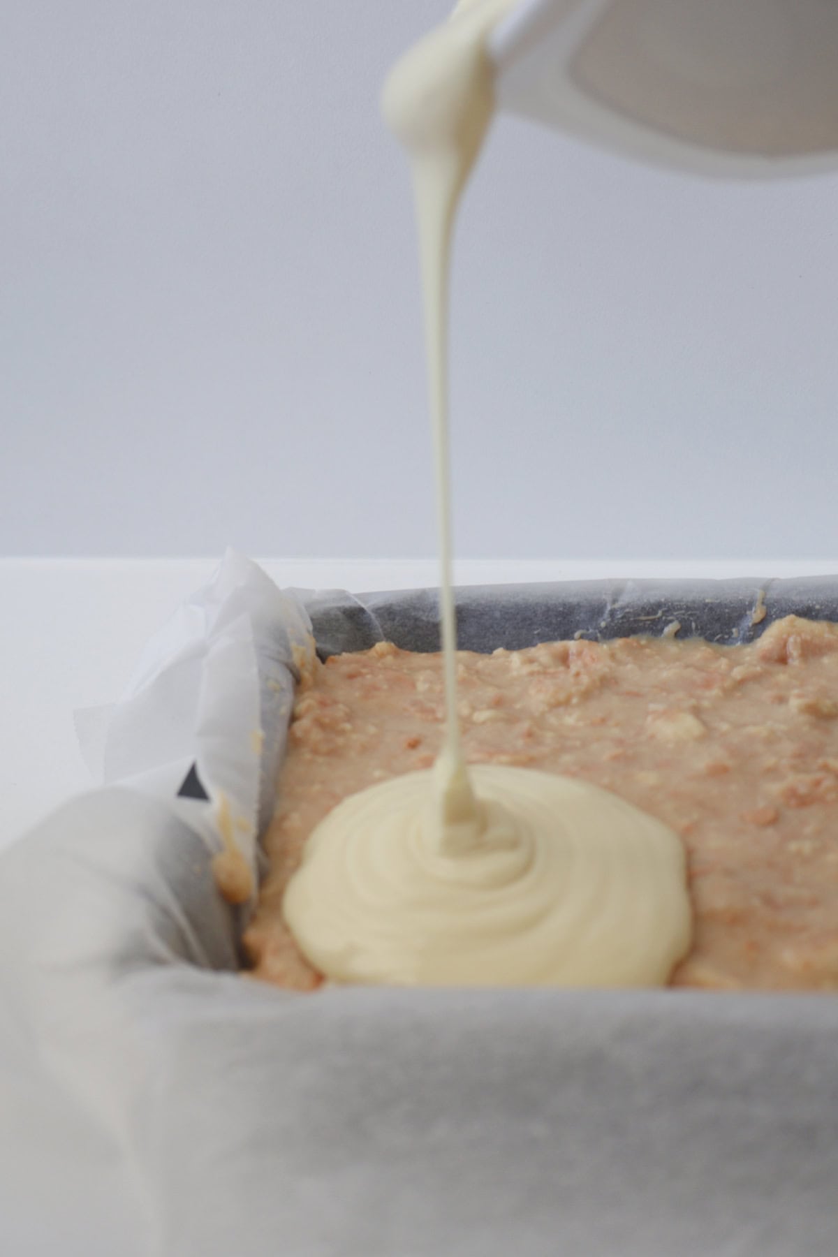 white chocolate being drizzled onto white chocolate hedgehog.