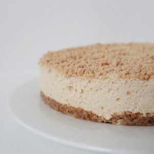 Caramilk Cheesecake on a white footed serving plate.